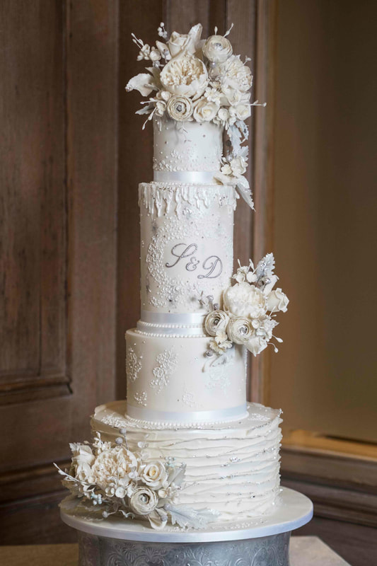 Dramatic white and silver winter wedding cake at Abbey House Hotel, The Lake District