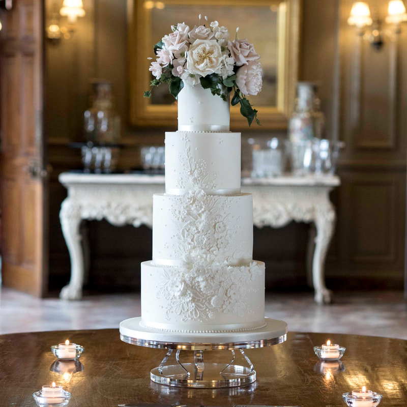 White wedding cake with sugar detail and sugar flowers